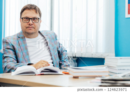 man working online on laptop at desk in office man working online on laptop at desk in office 124623971