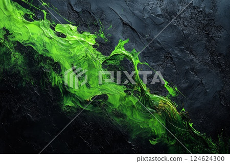 Neon green paint over a dark, textured black surface. 124624300