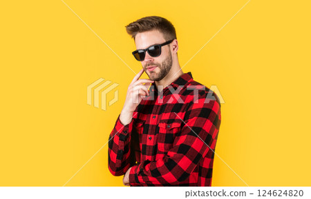 design is perfect. bearded man with sexy bristle in glasses. facial hair and skin care. handsome man wear checkered shirt. unshaven guy in casual style. hairdresser and barbershop. male beauty trend 124624820