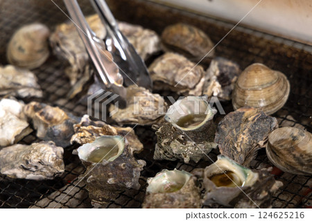 Oysters grilled on a barbecue 124625216