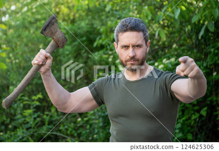 man threatening with hatchet wearing shirt, selective focus. man threatening with hatchet 124625306