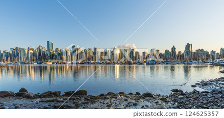 Vancouver downtown skyline panoramic view at sunset time. Skyscrapers reflection on the Vancouver Harbour. British Columbia, Canada. Vancouver downtown skyline panoramic view at sunset time. Skyscrapers reflection on the Vancouver Harbour. British Columbia, Canada. 124625357
