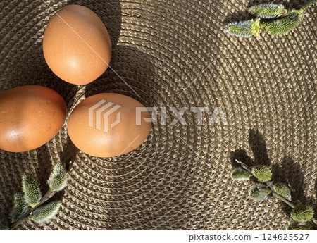Easter Eggs and Willow Branches on Woven Surface 124625527