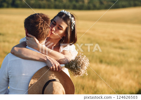 Enjoying the walk. Couple just married. Together on the majestic agricultural field at sunny day 124626503