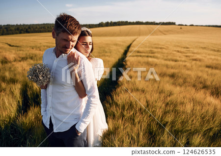 Beautiful sunlight. Couple just married. Together on the majestic agricultural field 124626535