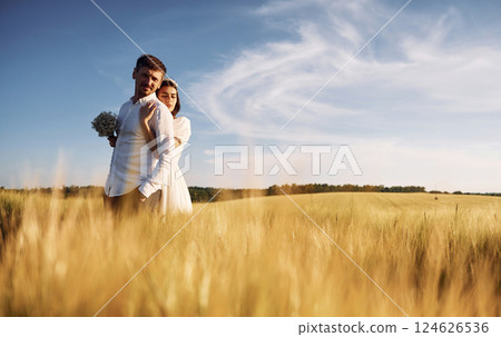 Beautiful sunlight. Couple just married. Together on the majestic agricultural field 124626536