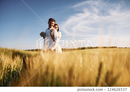 Beautiful sunlight. Couple just married. Together on the majestic agricultural field 124626537