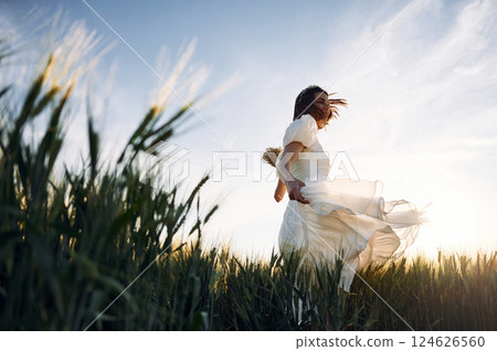 Happy people. Couple just married. Together on the majestic agricultural field at sunny day 124626560