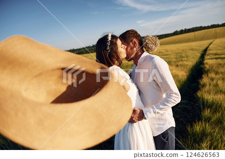 Happy people. Couple just married. Together on the majestic agricultural field at sunny day 124626563