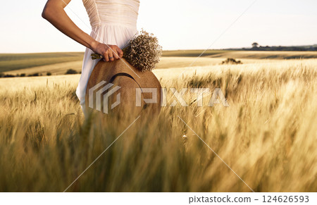 Nice landscape. Beautiful young bride in white dress is on the agricultural field at sunny day 124626593
