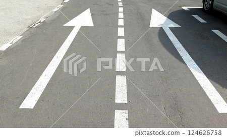 Clearly marked arrows guide traffic flow on a city road Clearly marked arrows guide traffic flow on a city road 124626758