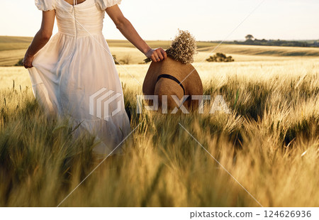 Beautiful young bride in white dress is on the agricultural field at sunny day 124626936