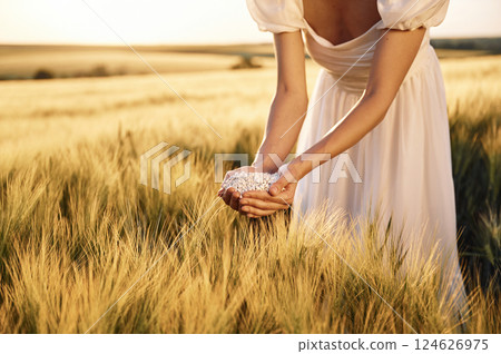 Many of the objects. Close up view of perlite in woman's hands that is on the agricultural field 124626975
