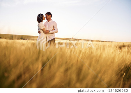 Standing and embracing. Couple just married. Together on the majestic agricultural field at sunny day 124626980