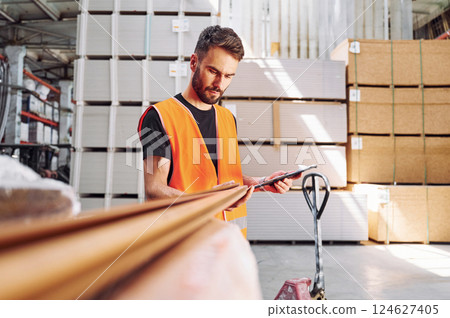 Checking quality of product. Storage worker is in the warehouse Checking quality of product. Storage worker is in the warehouse 124627405