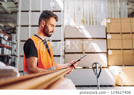 Checking quality of product. Storage worker is in the warehouse 124627406