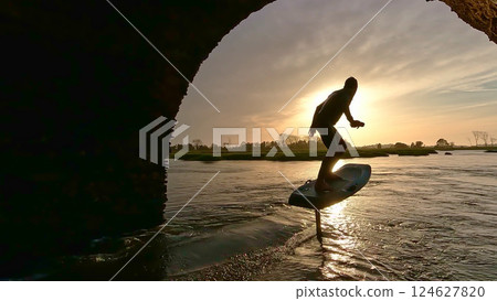 Hydrofoil rider gliding over the water Hydrofoil rider gliding over the water 124627820