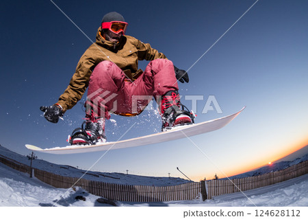 Snowboarding in the mountains 124628112