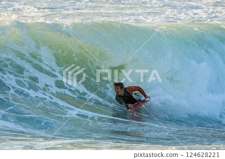 Bodyboarder in action 124628221