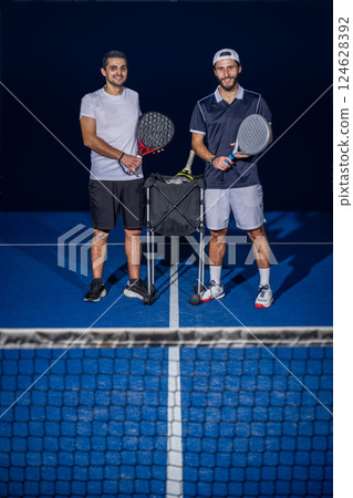 Two paddle players standing 124628392