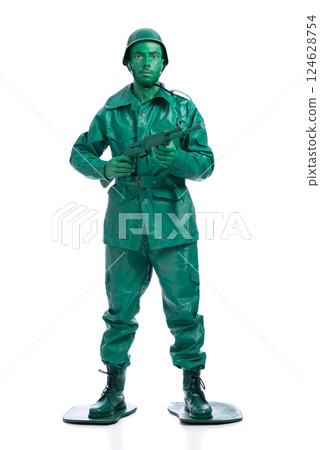 Man on a green toy soldier costume Man on a green toy soldier costume 124628754