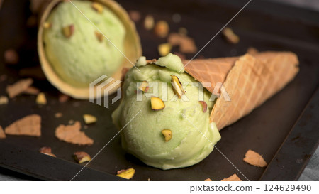 Pistachio ice cream in waffle cones 124629490
