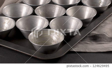 Baking forms smeared with butter Baking forms smeared with butter 124629495
