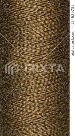 macro texture of a skein of brown sewing thread 124629785