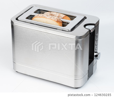 Stainless steel toaster with bread slices ready for toasting in kitchen setting Stainless steel toaster with bread slices ready for toasting in kitchen setting 124630285