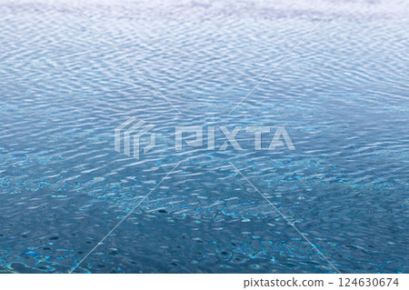 Tranquil image of a calm water surface with delicate ripples Tranquil image of a calm water surface with delicate ripples 124630674