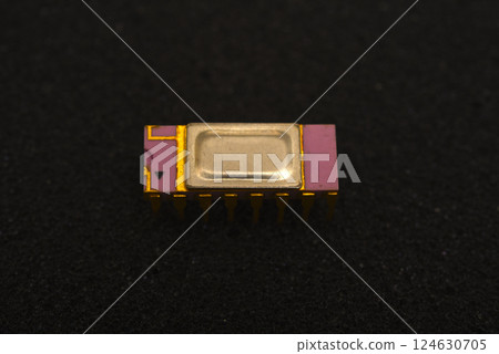 The microcircuit is on black foam. An integrated circuit for radio electronics. 124630705