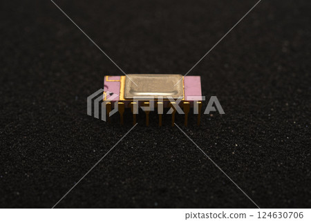 The microcircuit is on black foam. An integrated circuit for radio electronics. 124630706