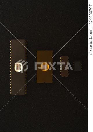 Several microchips on black foam. Old integrated circuits for radio electronics. Several microchips on black foam. Old integrated circuits for radio electronics. 124630707