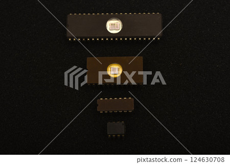 Several microchips on black foam. Old integrated circuits for radio electronics. Several microchips on black foam. Old integrated circuits for radio electronics. 124630708