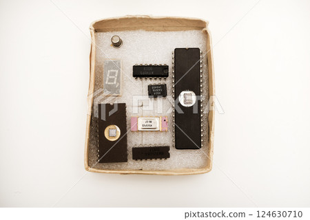 Several microcircuits on white foam. Old integrated circuits for radio electronics. 124630710