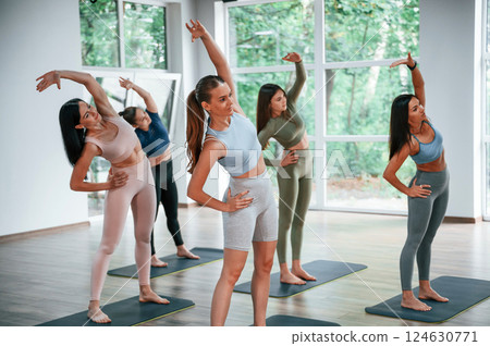 With hands up. Group of women practicing fitness in the gym With hands up. Group of women practicing fitness in the gym 124630771