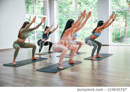 Exercise for legs and arms. Group of women practicing fitness in the gym Exercise for legs and arms. Group of women practicing fitness in the gym 124630787