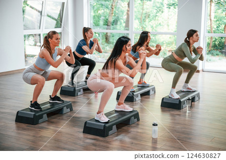 Endurance exercise. Group of women practicing fitness in the gym Endurance exercise. Group of women practicing fitness in the gym 124630827