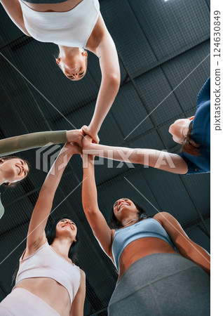 View from below. Conception of unity. Group of women practicing fitness in the gym 124630849