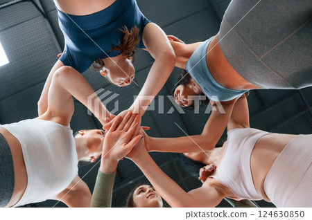 View from below. Conception of unity. Group of women practicing fitness in the gym 124630850