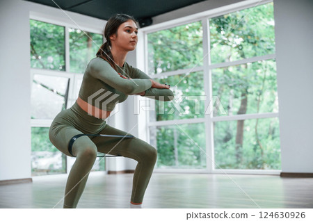 Exercise for legs strength. Woman in sportive clothes is having fitness day in the gym 124630926