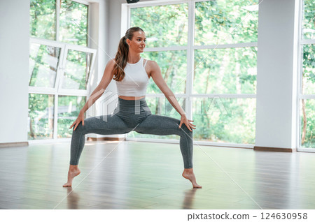 Legs spreading out. Woman in sportive clothes is having fitness day in the gym 124630958