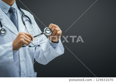Professional Man Holding Stethoscope in White Coat Ready for Work in Hospital Environment 124631070