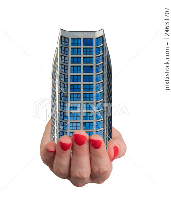 Hand holding a small model of a modern building with a glass window, home ownership and investment. 124631202