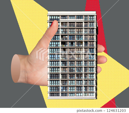 Hand holding a small model of a modern building, representing the concept of home ownership, 124631203