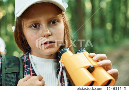 Portrait of girl that is in the forest at summer day time discovering new places Portrait of girl that is in the forest at summer day time discovering new places 124631545