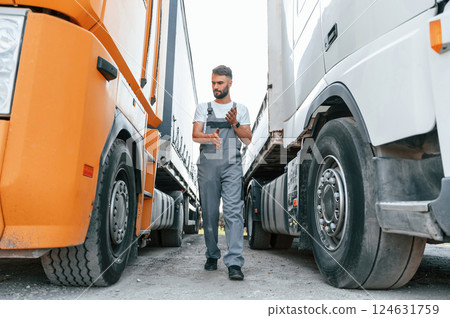 Job well done. Man in unifrom doing service for big truck vehicle 124631759