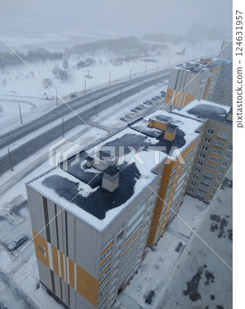 Snowy High-Rise Buildings Overlooking a Winter Road 124631957