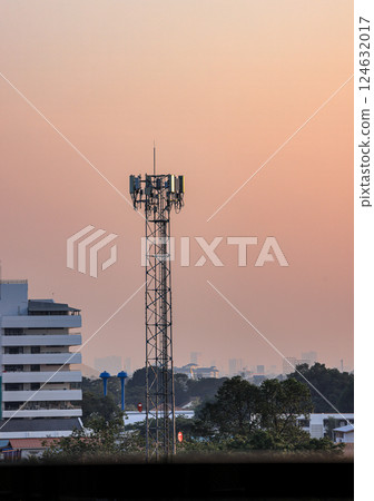 Wireless Communication Antenna pole, Mobile phone mast antenna pole on top of dilapidated building 124632017