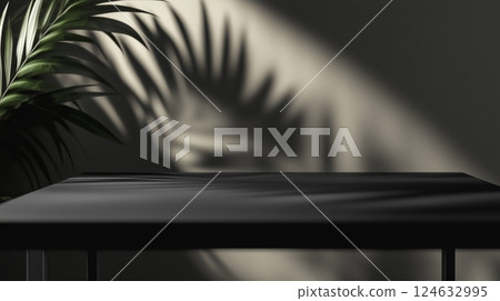 A black table and a plant in the background.  124632995